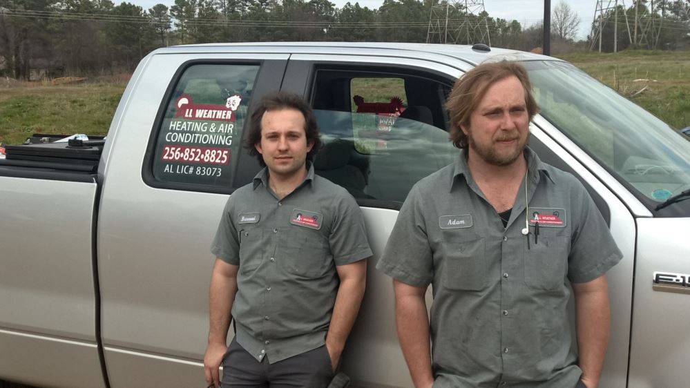 All Weather Heating & Air Conditioning team standing next to a work truck